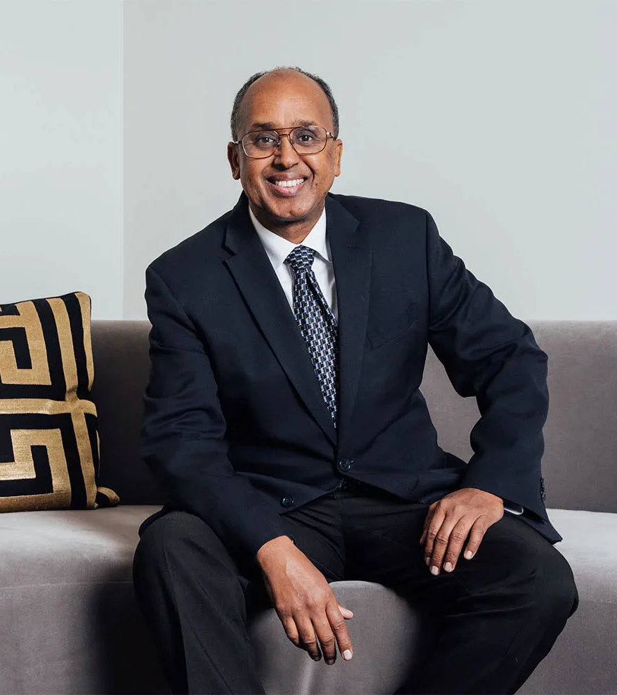 Dr. Mustafa Ahmed seated in a suit